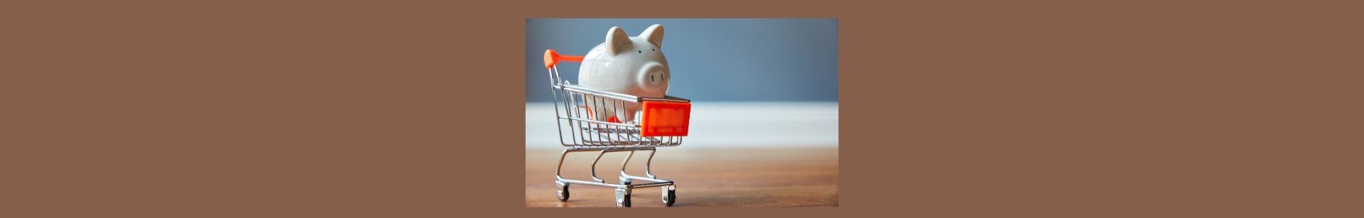 Eating Healthy On A Budget: Tips And Tricks. Medium brown background, a squre in the center, out of focus, gray wall, with white board, and brown in the front. A silver shopping cart with red, tag in front and red handle, a white porcelain pig in the cart.